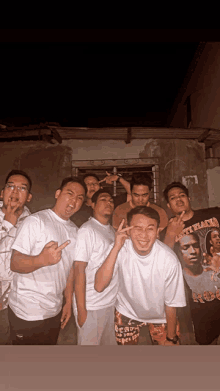 a group of young men are posing for a picture with one wearing a a ap rocky t-shirt