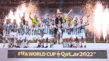 a group of soccer players are standing on a podium with a trophy .