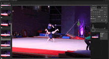 a computer screen shows a gymnast doing a handstand on the floor