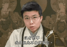 a man wearing glasses and a necklace with chinese writing