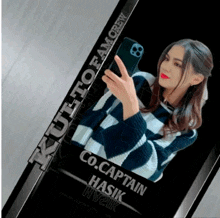 a woman taking a picture of herself with the name co.captain hasik