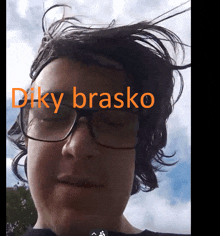 a close up of a person 's face with the words " diky brasko " written in orange