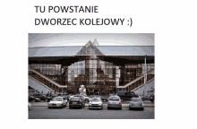 a row of cars are parked in front of a building that says " tu powstanie " on the top