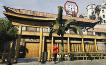 a man in a red jacket stands in front of a building that has chinese writing on it