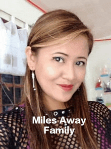 a close up of a woman 's face with the words miles away family written above her