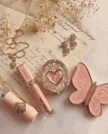 a letter from the new black penny company is laying on a table next to some makeup