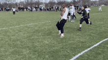 a group of football players on a field one of whom has the number 8 on his shirt