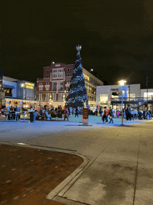 a large christmas tree in front of a building that says ' abercrombie & fitch '