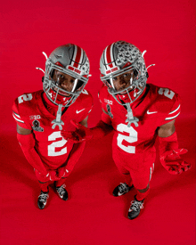 two ohio state football players wearing red uniforms