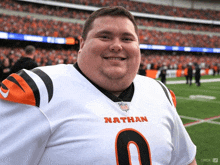 a man wearing a jersey that says nathan smiles for the camera