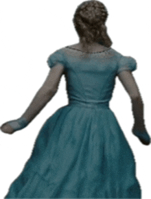 a woman in a blue dress is standing with her back to the camera