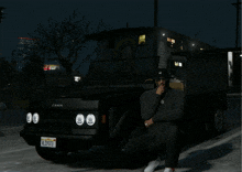 a man sits in front of a canis truck with a california license plate