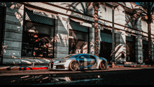 a blue car is parked in front of a building