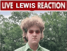 a man in a green shirt stands in front of a red sign that says live lewis reaction