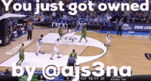 a basketball game is being played on a court with a caption that says you just got owned