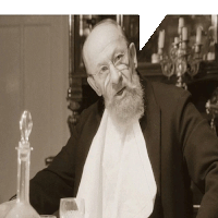 a man with glasses and a beard is sitting at a table with a glass and a decanter