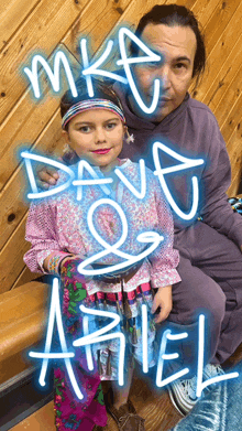 a woman sitting next to a little girl with the name ariel written in neon