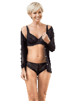 a woman wearing a black bra and panties is smiling