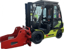 a clark forklift with a red claw attached