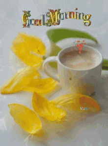 a cup of coffee and yellow petals with the words good morning