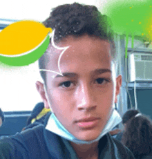 a young boy wearing a face mask is taking a selfie in a classroom .