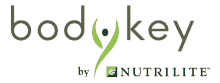 a logo for body key by nutrilite with a green leaf in the middle