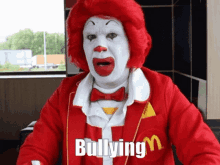 a clown in a mcdonald 's uniform is bullying