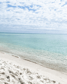 a beach with white sand and a turquoise water