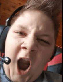 a person wearing a headset making a funny face with their mouth open