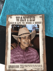 a wanted poster has a picture of a woman in a cowboy hat