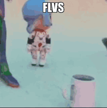 a doll in a space suit is standing next to a cup that says flvs on it