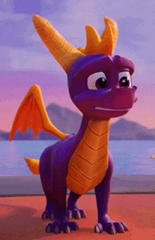 a purple and orange dragon with a crown on its head is standing on a beach .