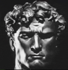 a black and white photo of a statue of a man 's face