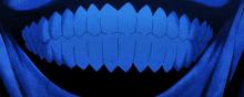 a close up of a person 's teeth with a blue background