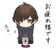 a boy is kneeling down holding a cup of tea in his hands .