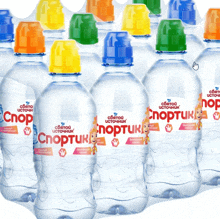 a bunch of bottles of sportuk water with different colors