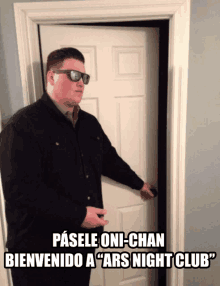 a man wearing sunglasses stands in front of a door that says pasele oni-chan