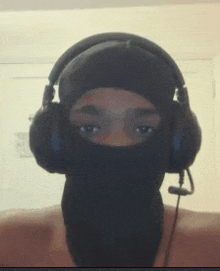 a man wearing a mask and headphones is looking at the camera