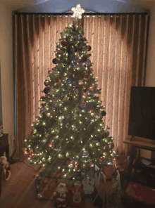 a christmas tree with a star on top of it in a living room