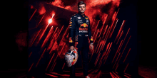 a man in a red bull uniform is holding a helmet .