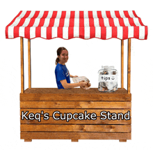 a girl stands behind a cupcake stand that says keq 's cupcake stand on it