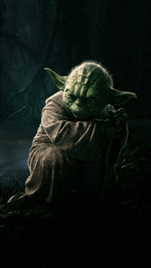 a picture of yoda from star wars with a dark background