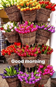 a bunch of baskets filled with flowers are stacked on top of each other on a rack .