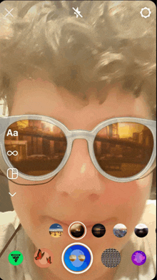 a person wearing sunglasses with the letters aa and infinity visible