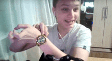 a young man wearing ear buds and a watch