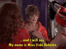 a woman in a red dress says and i will say my name is miss vida boheme