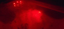 a red light is shining on the water in a bathtub