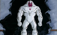 a cartoon character in a white suit with a pink face is standing in a hole in a wall .