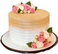 a white and gold cake with pink and white flowers on top