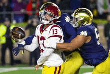 a football player is being tackled by another player during a game .